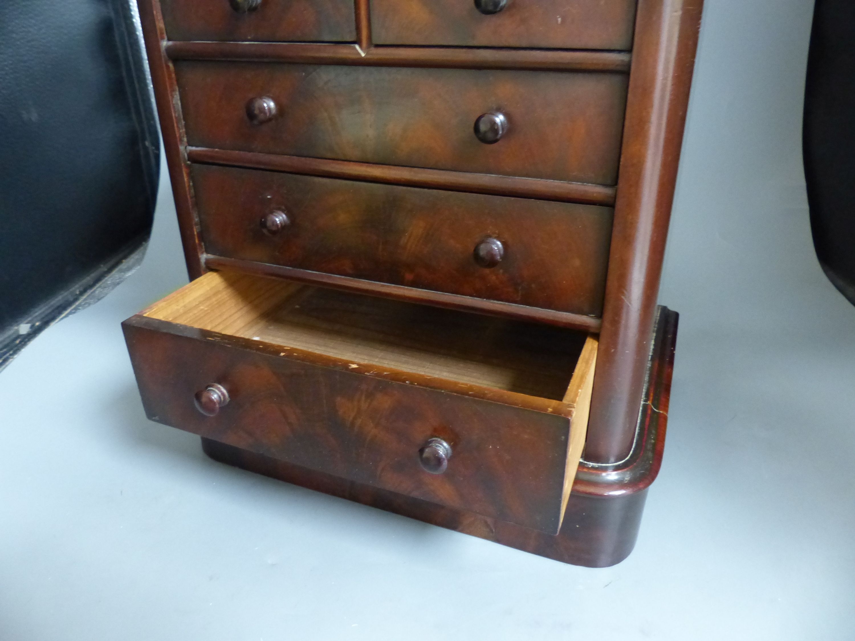 A Victorian miniature mahogany table top chest of drawers, height 35cm